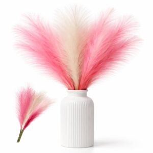 Artificial pampas grass stems in pink and white mixed colors arranged in a small vase for wedding and party decor