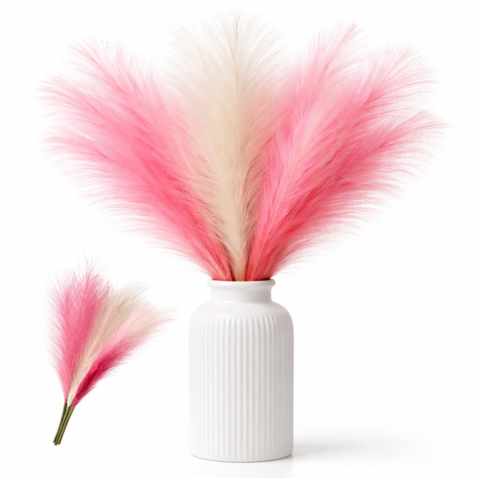 Artificial pampas grass stems in pink and white mixed colors arranged in a small vase for wedding and party decor