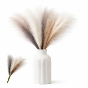 Artificial pampas grass stems in neutral mixed colors arranged in a small vase for wedding and home decor