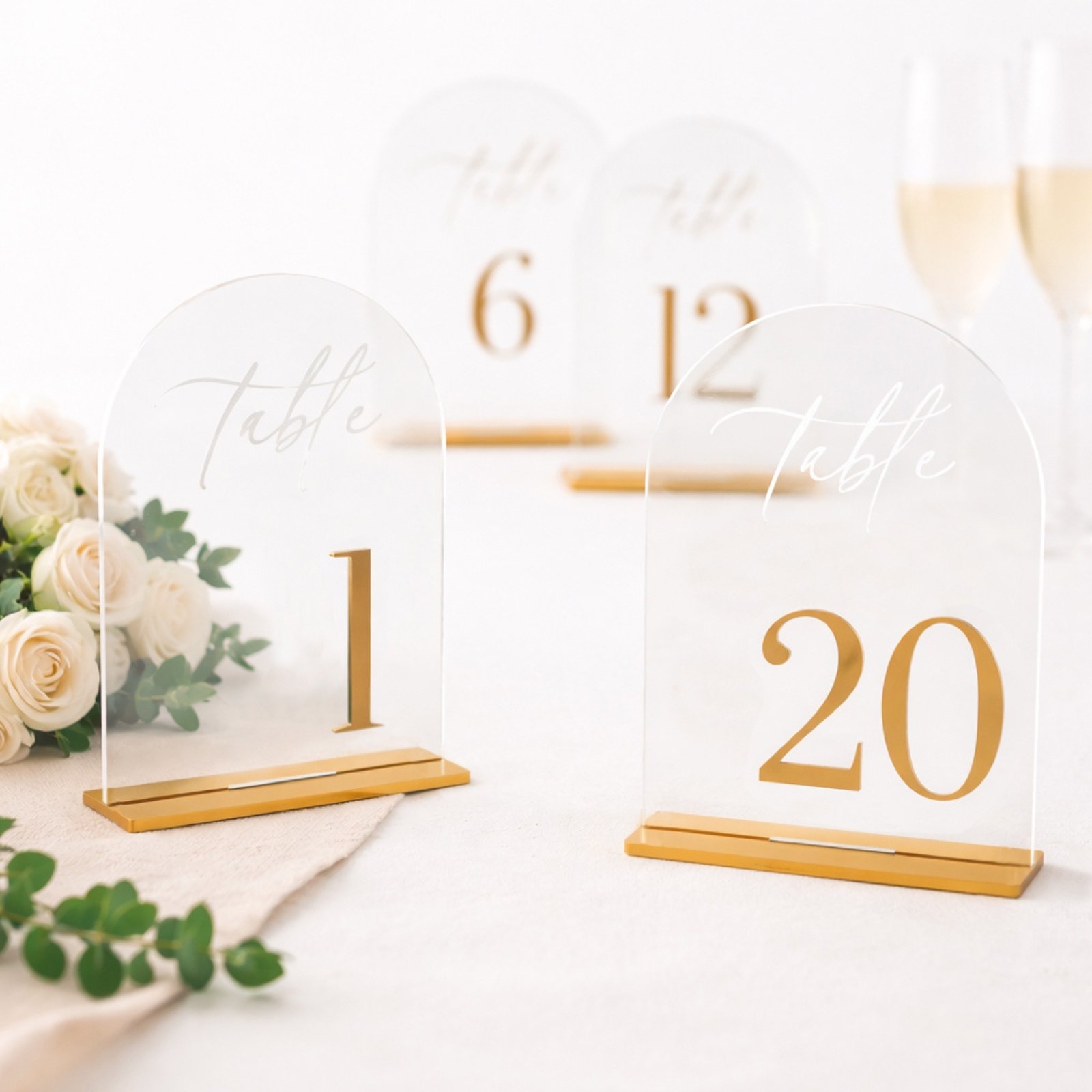 Clear acrylic arch signs numbered 1 to 20 with gold design and stands for reception tables